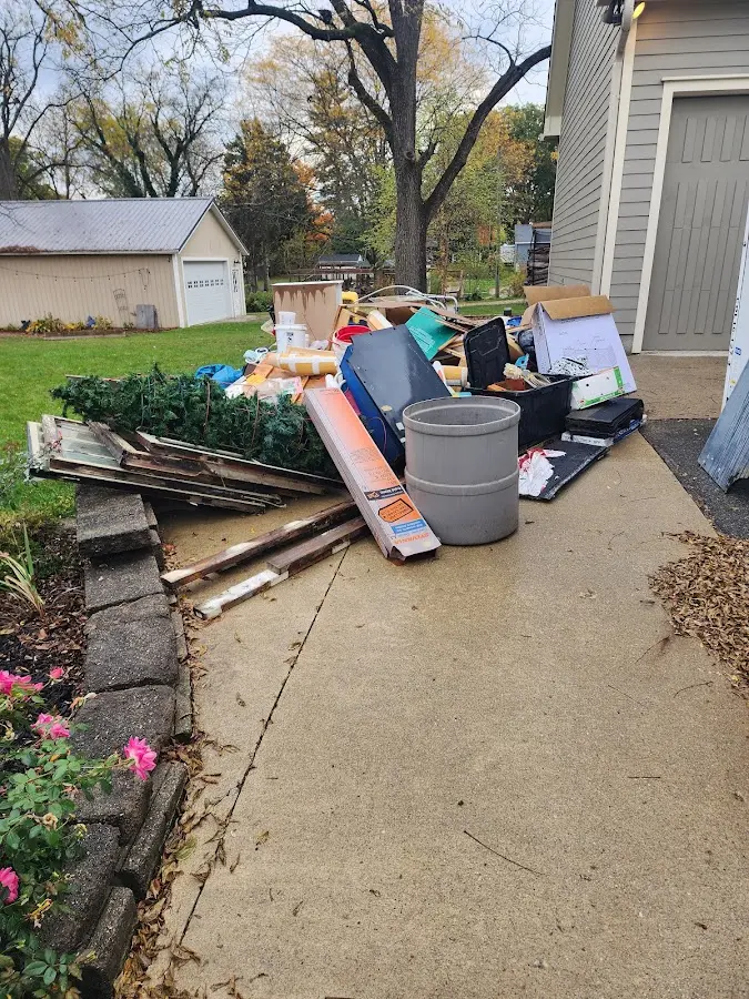 Dumpster being loaded with debris for Demolition Dumpster Rental in Anamosa